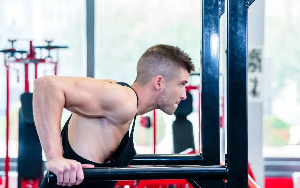 Athlete performing weighted dips with a dip belt