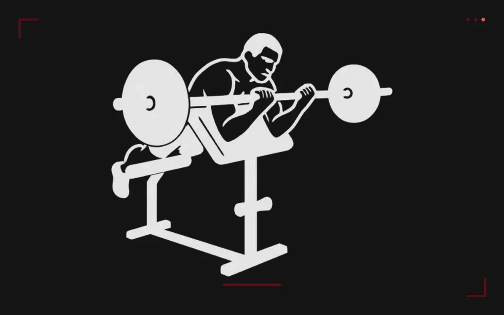 Spider curl: a man lying chest down on an incline bench, arms hanging, curling a loaded barbell
